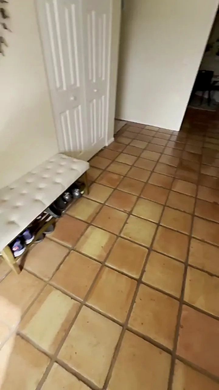 Hallway with the original terracotta tile floor before installation