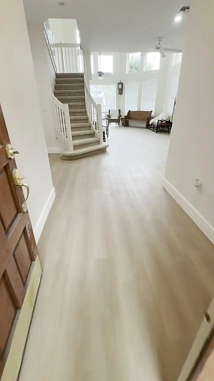 The same entry and staircase after light vinyl plank was installed