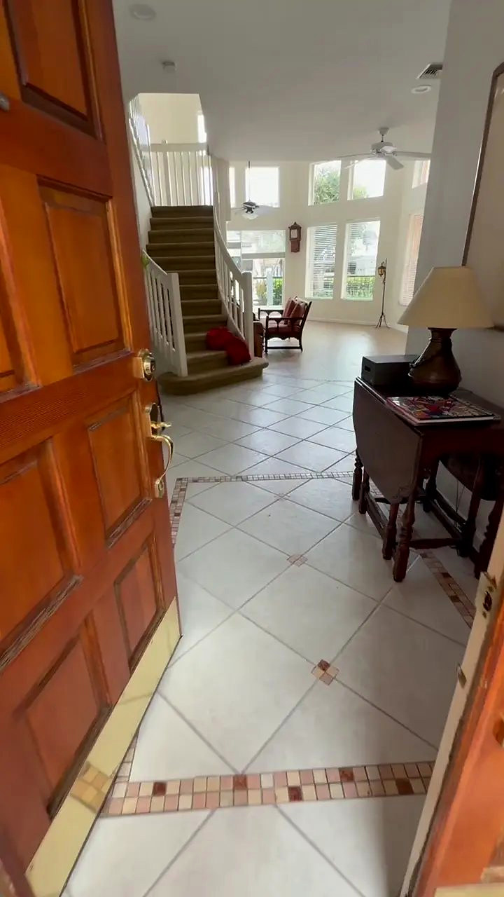 Entry and staircase with the original tile floor before installation