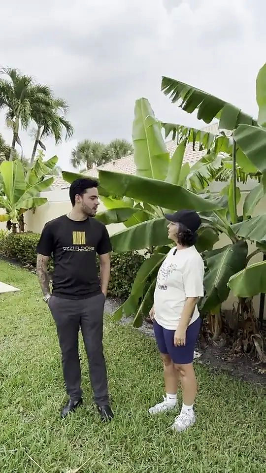 Walter of Ozzifloors talking with a customer on the lawn outside her house