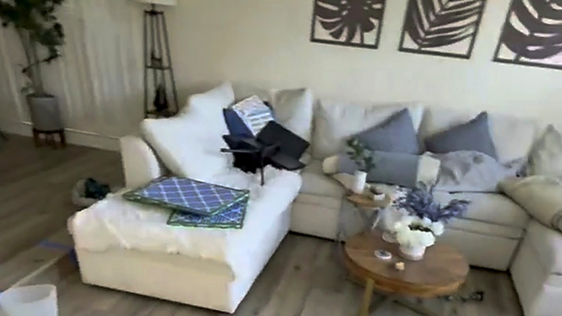 A finished living room with a pale plank floor and a white sectional