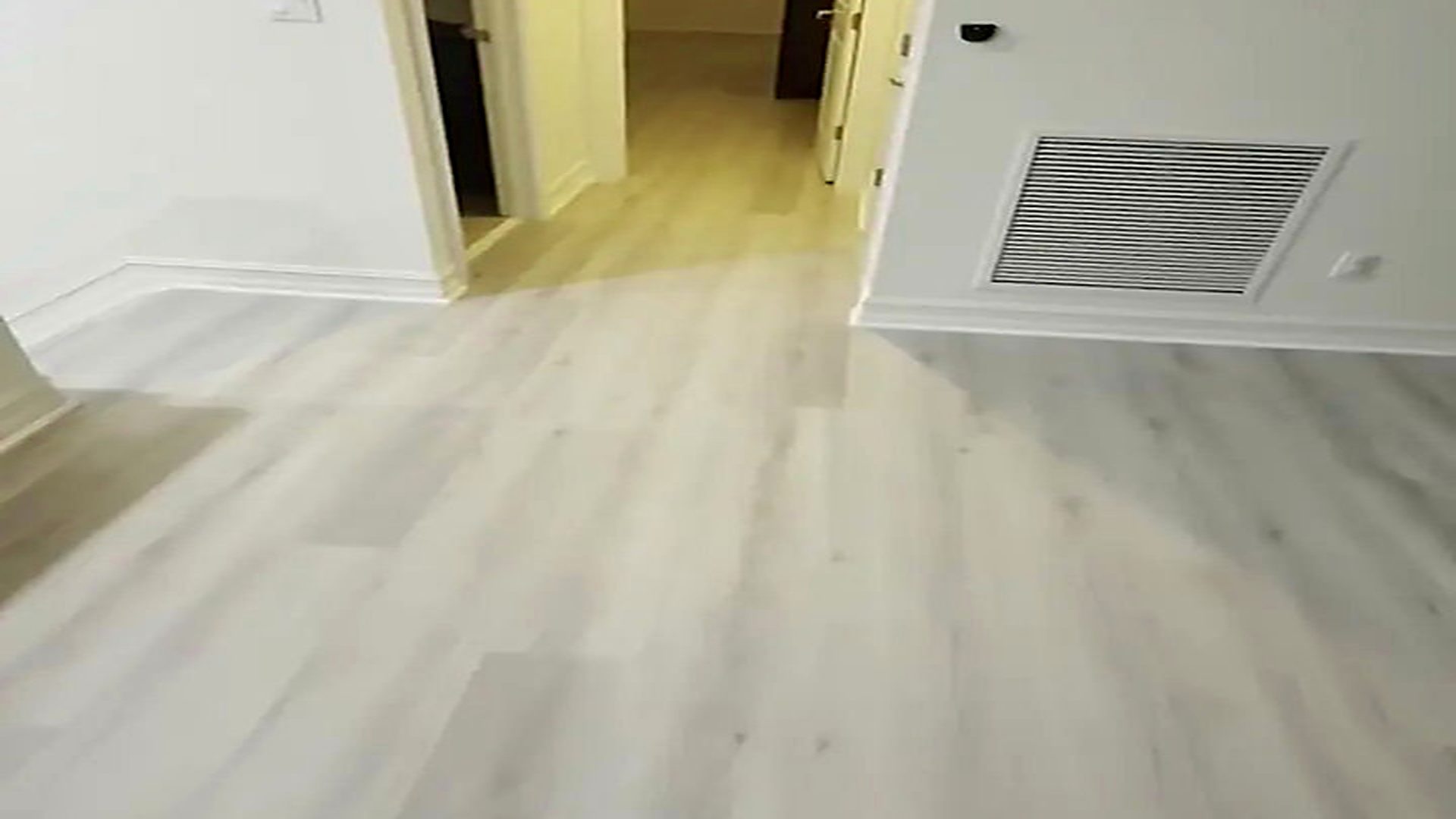 Wide plank vinyl flooring installed through a South Florida living room by Ozzifloors