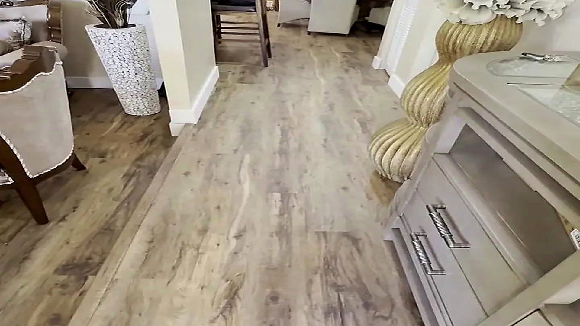 Wide plank vinyl flooring running through a furnished South Florida living and dining room