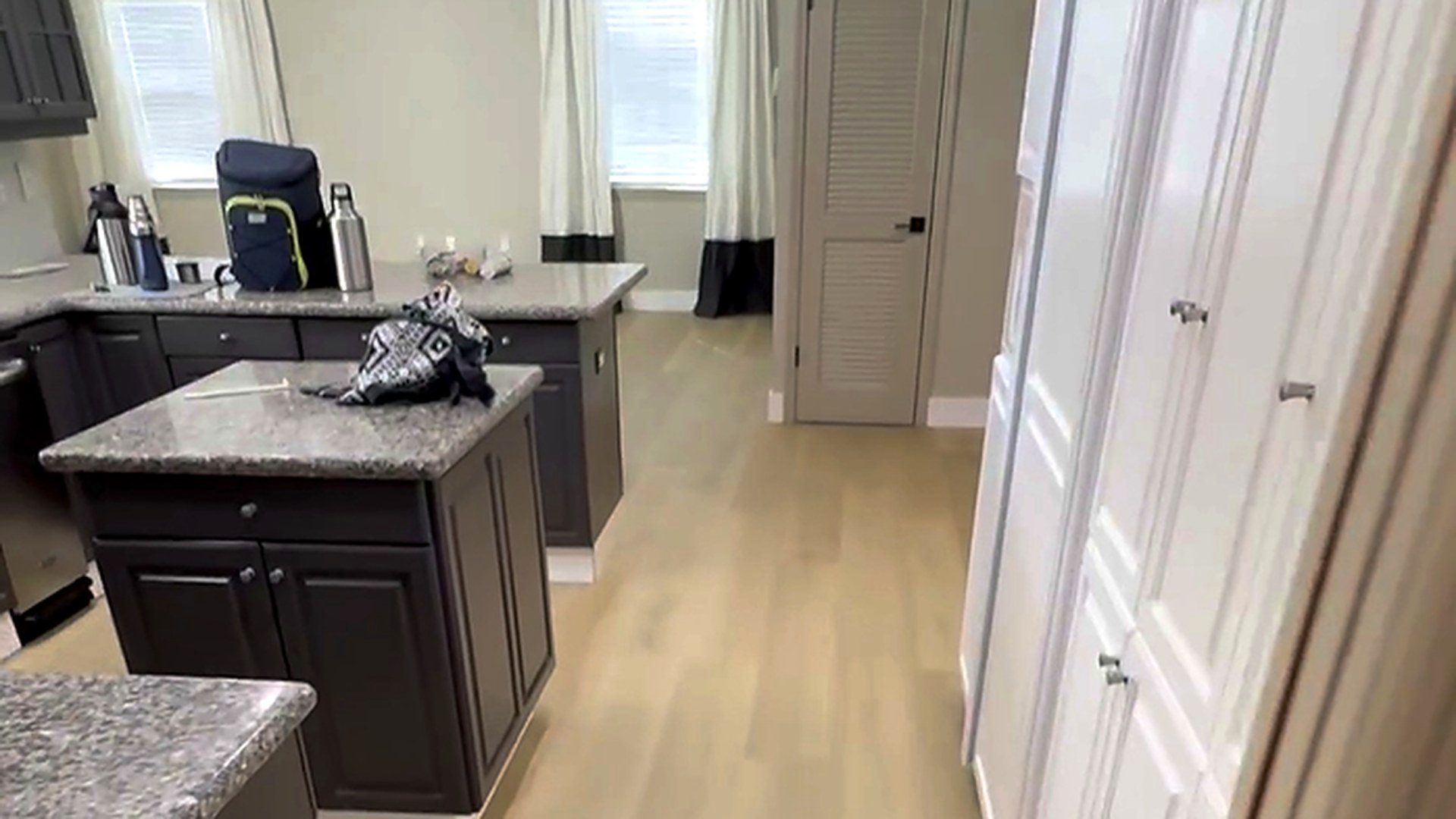 Wide plank vinyl flooring running through an open South Florida living space by Ozzifloors