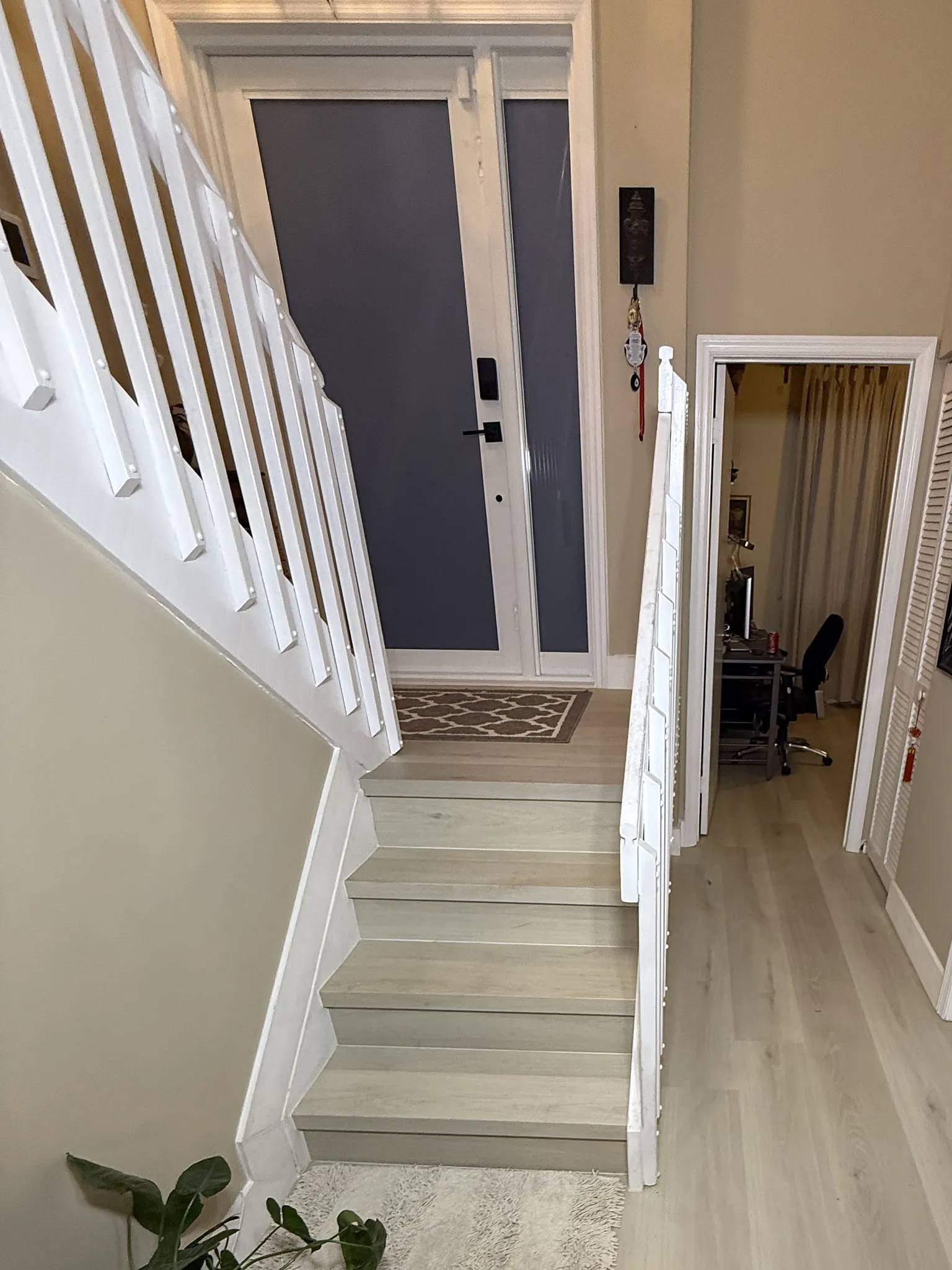 Pale plank entry hall and a stair run finished to match