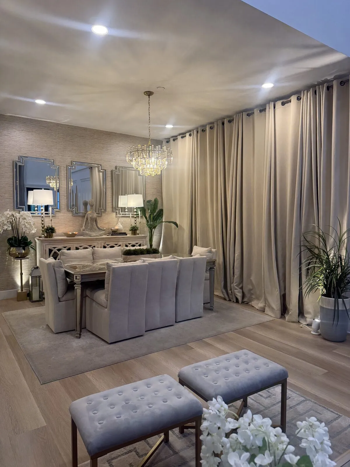 Light oak plank flooring under a formal dining room table and chandelier