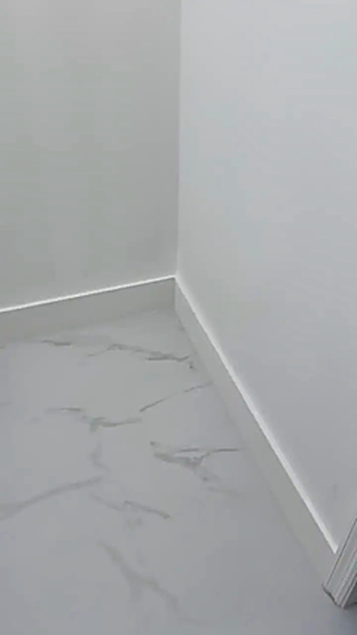 Large format white tile flooring installed in a Miami home